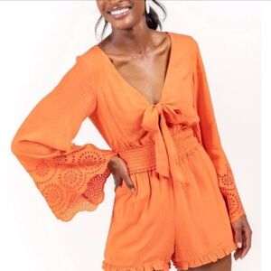 Blue Rain of Francesca’s eyelet Smocked Waist Romper in Red w/long, bell sleeves